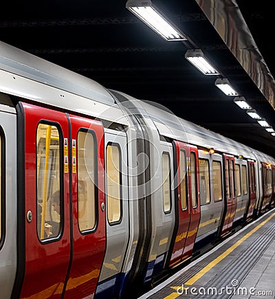 Train on the platform at Euston Square Underground Station, London UK, showing reflection of train on ceiling above. Editorial Stock Photo