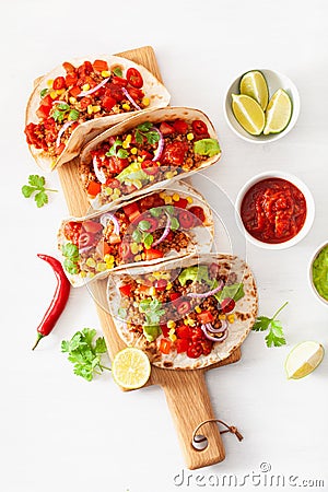 Mexican beef and pork tacos with salsa, guacamole and vegetables Stock Photo