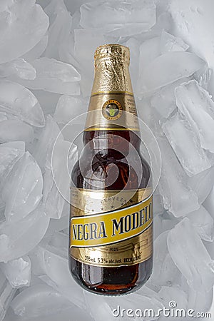 A Mexican beer Negra Modelo bottle on a bed of ice Editorial Stock Photo