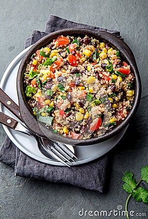 Mexican black bean corn quinoa salad in clay bowl top view, copy space Stock Photo