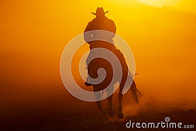 A Mexican Charro Cowboy Rounds Up A Herd of Horses Running Through The Field On A Mexican Ranch At Sunrise Stock Photo