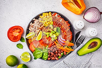 Mexican chicken burrito bowl with rice, beans, tomato, avocado,corn and spinach, top view. Mexican cuisine food concept Stock Photo
