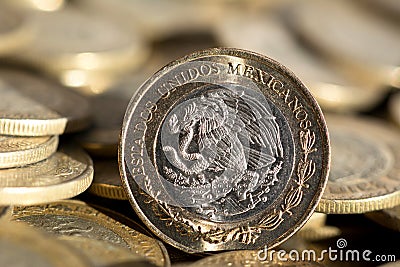 Mexican currency in the foreground, with many more coins in the background, macro, Horizontal Stock Photo