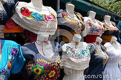 Mexican embroidered dresses on street market stall Editorial Stock Photo