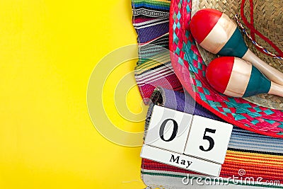Mexican fiesta poster and Cinco de Mayo party concept theme with calendar on may 5th, red and blue maracas, sombrero and Stock Photo