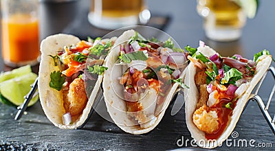 Mexican fish tacos in metal tray with hot sauce Stock Photo