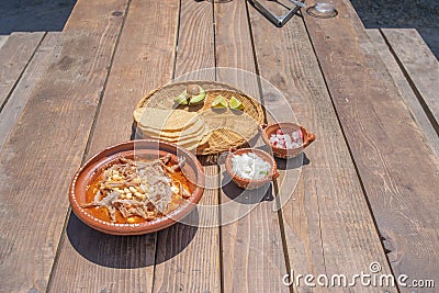 Mexican food dish. pozole with toasts, avocado and onion Stock Photo