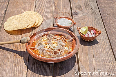 Mexican food dish. pozole with toasts, avocado and onion Stock Photo