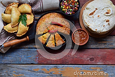 Mexican food mix - tacos, cornbread, salsa with tomato, red onion, lime, cilantro, corn and hot pepper sauce, empanadas. Copy spac Stock Photo