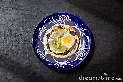 Mexican green ranchero eggs on tortilla toast Stock Photo