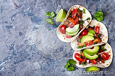 Mexican grilled chicken tacos with avocado, tomato, onion on rustic stone table. Recipe for Cinco de Mayo party. Stock Photo