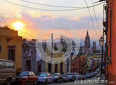 Multicolored Mexican Houses and Suspended Street Decorations at Sunset Stock Photo