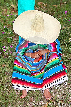 Mexican lazy sombrero hat man poncho nap garden Stock Photo