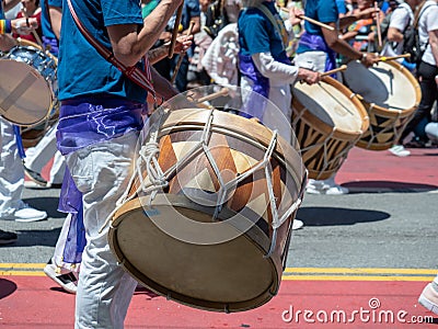 Mexican marching band beats on drums while walking down streets Editorial Stock Photo