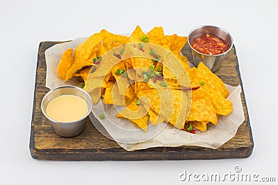 Mexican nachos chips with sauces on wooden board isolated on white background Stock Photo