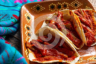 Mexican nopal cactus tacos with guajillo red sauce on wooden background Stock Photo