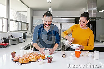 Mexican people baking and eating bread called pan de muerto traditional from Mexico in Halloween Stock Photo