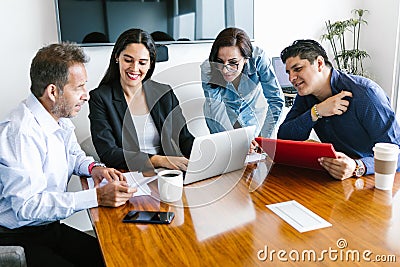 Mexican people in business meeting using computer in office in Latin America Stock Photo