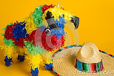 Mexican pinata and sombrero on yellow Stock Photo