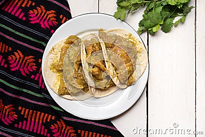 Mexican pork chicharron with green sauce tacos on white background Stock Photo