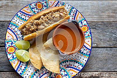 Mexican pork sandwich with red sauce also called Torta ahogada Stock Photo