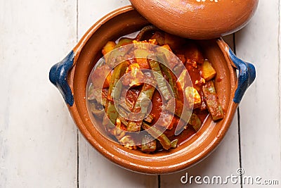 Mexican potato and nopal cactus stew with red sauce on white background Stock Photo