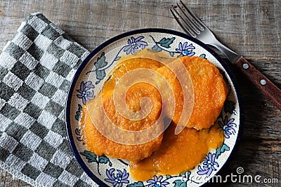 Mexican potato patties with red sauce on wooden background Stock Photo