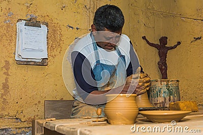 Mexican potter craftsman, working the clay with his hands Editorial Stock Photo