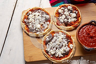 Mexican red sopes with cheese and beans on white background Stock Photo