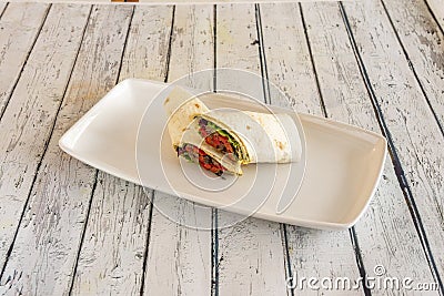 Mexican roast beef and peppermint burrito with lots of red pepper and lettuce rolled Stock Photo