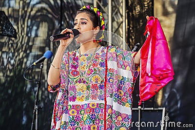 Mexican singer in traditional dress performing at Latino festival in city center Editorial Stock Photo