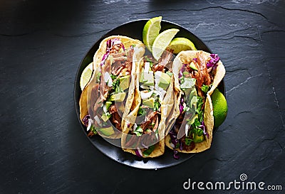 Mexican street tacos flat lay composition with pork carnitas, avocado, onion, cilantro, and red cabbage Stock Photo