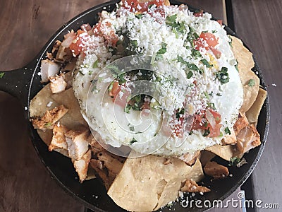 Mexican style breakfast, egg over avocado,salsa,chicken and chips Stock Photo