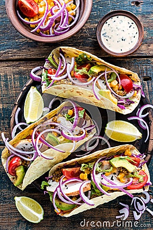 Tacos with chicken meat, vegetables and fresh greens Stock Photo