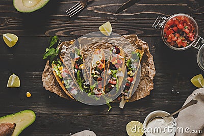 Mexican tacos with salsa and avocado on the wooden background, top view Stock Photo