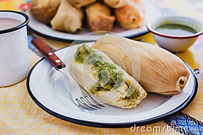 Mexican tamales of corn leaves with green sauce and atole, Tamales Breakfast in Mexico Stock Photo