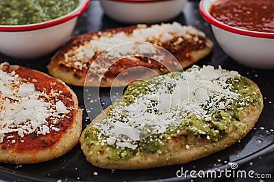 Mexican tlacoyos with green and red sauce, Traditional food in Mexico Stock Photo