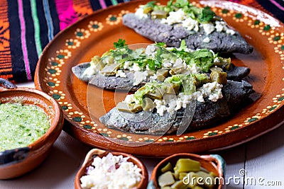 Mexican tlacoyos with green sauce Stock Photo