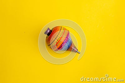 Mexican toys, Trompo from Wooden in Mexico on yellow background Stock Photo
