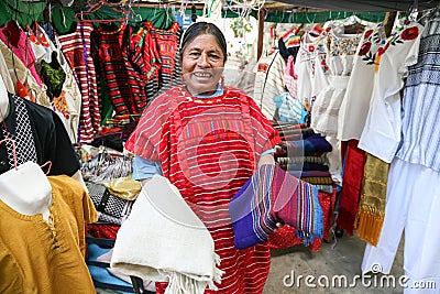 Mexican woman selling traditional mexican shawl and clothes in Editorial Stock Photo