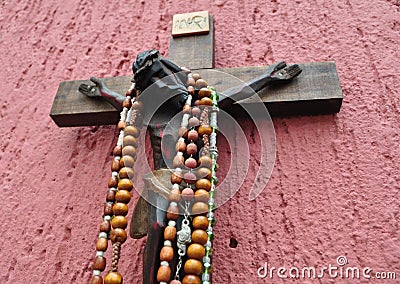 Mexican wooden crucifix with several rosaries Stock Photo