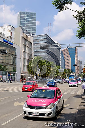 Urban scene with traditional pink taxis in downtown Mexico City Editorial Stock Photo