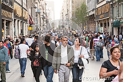 people walking by the Calle Francisco I.Madero in Hictorical center of Mexico City Editorial Stock Photo