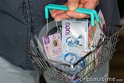 Mexico money, Man holding a shopping cart full of money, Financial concept, Shopping and expenses for daily life, Mexican pesos Stock Photo