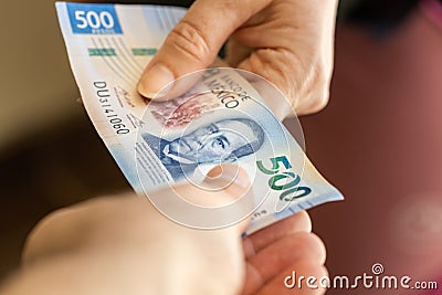 Mexico 500 pesos, Passing money from hand to hand, Financial business concept, Mexican currency Stock Photo