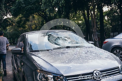 MEXICO - SEPTEMBER 19: Car with broken windshield by fallen debris due to the earthquake Editorial Stock Photo