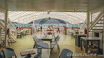 View from inside a boat, you can see the tables for the crew Editorial Stock Photo