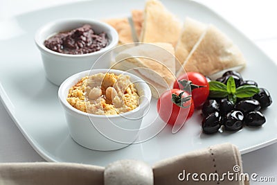 Meze with tomato, olives, and pita bread Stock Photo