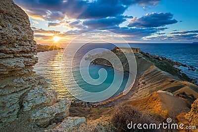 Mgarr, Malta - Panorama of Gnejna bay, the most beautiful beach in Malta at sunset Stock Photo