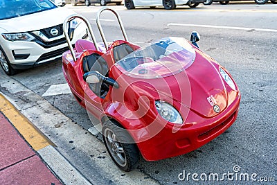 Miami Beach, Florida USA - April 14, 2021: red scootcoupe moped, corner view. tree-wheel scooter Editorial Stock Photo